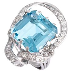 Exquisite Aquamarine square step cut ring, a true embodiment of elegance and sophistication. Crafted with meticulous attention to detail, this stunning piece features a mesmerizing Aquamarine gemstone, estimated to weigh approximately 11.00 carats. The Aquamarine takes center stage, showcasing its captivating blue hue and impeccable clarity. Its square step cut adds a touch of modernity, enhancing the gemstone’s natural beauty. Surrounding the Aquamarine are dazzling round cut diamonds, carefully set on a band crafted from a combination of platinum and white gold. The combination of the Aquamarine’s serene color, the brilliance of the diamonds, and the luxurious metals used in the ring’s construction create a harmonious and eye-catching design. This exquisite piece is perfect for those see Ring Aesthetic, Platinum Diamond Rings, Aesthetic Movement, Step Cut, Aquamarine Gemstone, Platinum Ring, Gem Stone, Center Stage, Belleza Natural