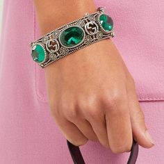 Bracelet is crafted in Italy with the namesake motif interspersed with flowers - an archival tradition of the house - punctuated with faceted green crystals, and secures with a tiger - head bayonet fastening, for a sense of old-world elegance.Sterling silverMaximum width of band 1.1in/2.9cm Maximum width of opening 2.4in/6cm Inner width when closed 2.4in/6cmMade in Italy Luxury Green Cuff Bracelet For Formal Occasions, Luxury Green Oval Bracelet, Green Jeweled Bangle Bracelet, Designer Silver Gucci Jewelry, Oval Jeweled Crystal Jewelry, Luxury Silver Gucci Jewelry, Luxury Jeweled Metal Bracelets, Luxury Jeweled Crystal Jewelry, Elegant Green Cuff Bracelet For Formal Occasions