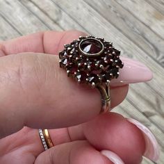 Vintage Bohemian GARNET Ring US 6.25 in Sterling Silver. Stamped "Silver" on the inside. Was certainly gold plated Sterling  Vermeil ( gold wash).. looks silver but may be some remnants of gold wash. Truly beautiful antique garnet cluster ring! Excellent condition . Makes a beautiful unique gift.  Will come in a small red ring box ready to gift.  Free shipping in the USA. All sales final . Fine Jewelry Garnet Cluster Ring, Fine Jewelry Round Cluster Ring With Garnet, Garnet Cluster Ring As A Gift, Garnet Gemstone Cluster Ring, Heirloom Garnet Cluster Ring With Gemstones, Heirloom Garnet Cluster Ring For Anniversary, Heirloom Style Round Garnet Cluster Ring, Heirloom Style Garnet Cluster Ring, Heirloom Garnet Cluster Ring