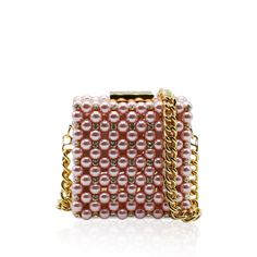 Handcrafted with care in Italy with up to 8 hours of hand work, this clutch is a masterpiece of luxury. This clutch boasts a metal frame available in gold or silver, delicately adorned with Artisan pearls and sparkling crystals, catching the light with every movement.Luxurious leather graces the interior, offering both sophistication and functionality. Material: Metal Frame, Artisan pearls and sparkling crystals, Leather Unlined Height: 10 cm Width: 10 cm Depth: 6 cm Complete with a versatile 80 Chic Pearl Clutch For Formal Occasions, Luxury Pearl Clutch For Formal Occasions, Elegant Rectangular Jewelry For Evening, Pearl Evening Bag With Pearl Handle, Elegant Bags With Pearl Chain, Glamorous Pearl Clutch With Pearl Handle, Pearl Embellished Clutch, Luxury Pearl Evening Bag For Party, Evening Pearl Embellished Bag