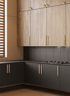 an empty kitchen with wooden cabinets and black counter tops, along with wood flooring