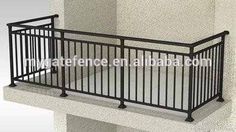 an iron balcony railing on the side of a building