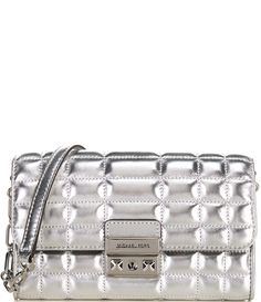 From Michael Kors&#x2C; the Tribeca Large Silver Metallic Leather Convertible Crossbody Bag features:Crossbody bagMetallic leather100% leatherSilver-tone hardwareExterior details: back slip pocketInterior details: back slip pocket&#x2C; 8 card slotsLining: 100% polyesterSnap fasteningApprox. 7.5”W X 4.5”H X 1.25”DRemovable strap approx.: 20.5”Imported. Leather Top Handle Bag With Silver-tone Logo Plaque, Rectangular Leather Shoulder Bag With Silver-tone Logo, Chic Top Handle Bag With Silver-tone Logo Plaque, Modern Travel Bags With Silver-tone Logo Plaque, Modern Travel Bag With Silver-tone Logo Plaque, Modern Travel Bag With Silver-tone Logo, Evening Leather Bag With Silver-tone Logo Plaque, Chic Leather Bag With Silver-tone Logo, Silver-tone Logo Plaque Shoulder Bag