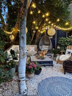 an outdoor patio with lights strung from the trees