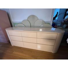 a white dresser sitting on top of a hard wood floor