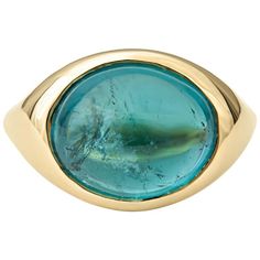 This ring features a 7.58ct oval cabochon teal tourmaline bezel set in a 14kt yellow gold ring. The ring itself is a size 6, but can be resized to be smaller or larger upon request. Luxury Gold Enamel Ring With Cabochon, Luxury Turquoise Gemstone Ring With Oval Cabochon, Luxury Oval Cabochon Turquoise Gemstone Ring, Luxury Enamel Cabochon Ring, Luxury Elegant Turquoise Oval Cabochon Ring, Luxury Turquoise Gemstone Ring, Oval Cabochon, Luxury Turquoise Gemstone Ring Oval Cabochon, Luxury Adjustable Cabochon Ring, Luxury Artisan Cabochon Rings