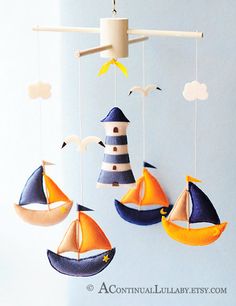 a mobile with sailboats and lighthouses hanging from it