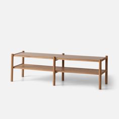 two wooden benches sitting next to each other on top of a white surface with no one in it