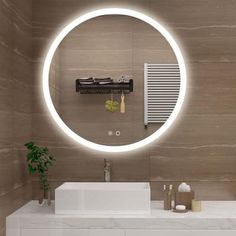 a bathroom sink with a round mirror above it