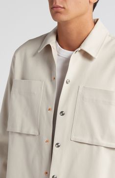 Roomy and relaxed, this overshirt made of sanded cotton twill features hand-brushed metallic snaps and a touch of stretch to keep you moving comfortably. 29" length (size Medium) Front snap closure Spread collar Long sleeves with two-snap cuffs Chest bellows pockets 98% cotton, 2% elastane Dry clean Imported Casual Beige Tops With Snap Buttons, Neutral Collared Shirt For Everyday, Cream Button-up Shirt With Pockets, Beige Spread Collar Shirt For Everyday, Everyday Neutral Collared Shirt, Daily Beige Shirt With Spread Collar, Everyday Beige Shirt With Buttons, Everyday Beige Shirt With Spread Collar, Beige Everyday Shirt With Spread Collar