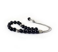 Handcrafted Greek Komboloi - Worry Beads created from silver tone metal chain of 20 black onyx Beads, 2 metal round beads and triangle shape metal Master Bead. A pocket sized set of greek worry beads which can be used for passing time and relaxation. It would also make a beautiful gift. Features: Item Length: 23cm / 9 inches Beads Size: 10mm / 0.40 inches Beads Material: Black onyx beads Metal Materials: Silver tone alloy Here you can browse more items in our shop: https://www.etsy.com/shop/sunn Greek Worry Beads, Chistmas Gift, Worry Beads, Onyx Bead, Beaded Material, Triangle Shape, Necklace Sizes, Metal Beads, Metal Chain