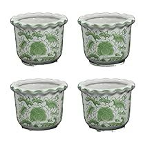 four glass bowls with green designs on them