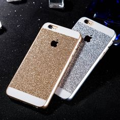 two iphones sitting next to each other on a black table with silver and gold glitter