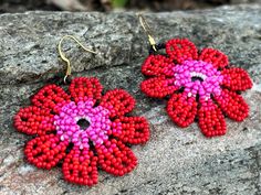 Add a touch of vibrant elegance to your look with these handmade beaded flower earrings. Each pair features a unique blend of colors, from deep blues to warm oranges and pinks, inspired by the beauty of nature. Perfect for any occasion, these earrings are lightweight and versatile, making them an ideal accessory for both casual and formal outfits. Whether you're looking to brighten up your wardrobe or searching for a thoughtful gift, these floral earrings are sure to make a statement.🌼🌸 Featur Adjustable Red Flower Beaded Earrings, Handmade Red Flower Beaded Earrings, Red Handmade Flower Earrings, Multicolor Beaded Flower Earrings With Flower Charm, Multicolor Flower-shaped Beaded Earrings With Flower Charm, Multicolor Flower Shaped Beaded Earrings With Flower Charm, Handmade Red Flower Earrings With Round Beads, Handmade Flower-shaped Red Earrings, Red Flower Earrings With Colorful Beads As Gift