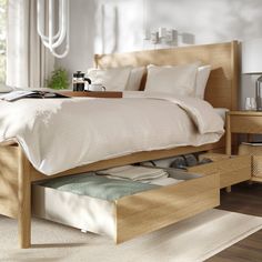 a bed with drawers underneath it in a bedroom