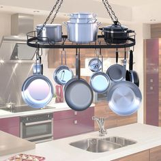 a kitchen filled with pots and pans hanging from a metal rack over a sink