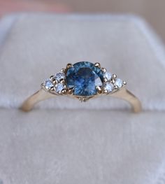 SKY BLUE MONTANA SAPPHIRE RING Once upon a time, the ancient Persians thought sapphires were so special, they believed that the earth had been created on top of the biggest blue sapphire ever, and that's why the sky was blue... It gives so romantic meaning for a blue sapphire engagement ring. One one represents a blue sapphire rig with diamonds to her or his beloved, it's considered representative of sincerity and faithfulness. This nature inspired floral design engagements ring features magic t Heirloom Blue Sapphire Diamond Ring, 14k Gold Blue Sapphire Ring With Center Stone, Blue Celestial Ring With Center Stone, Heirloom Blue Topaz Rings In Blue, Celestial Blue Rings With Accent Stones, Blue Celestial Rings With Accent Stones, Blue Celestial Sapphire Promise Ring, Celestial Blue Sapphire Promise Ring, Blue Sapphire Birthstone Ring With Round Cut