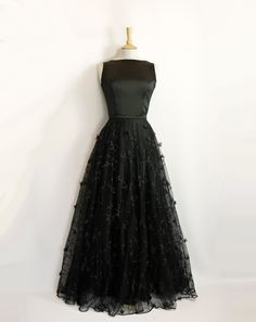 "This stunning full length bridal overskirt is made from our beautiful 3D Peggy Lace. It is a generous full-circle skirt with an extra layer of tulle underneath for extra volume and a high fitted waistband in satin crepe. It is seen here in a dramatic black but can also be made in ivory. Photographed in black with the Elvira Wedding Gown in Black Satin Crepe: https://www.etsy.com/uk/listing/1403872161/elvira-wedding-gown-in-black-satin-crepe?click_key=75e96a7c5c1443f514a630a1b8cd8b2087eaa4a8%3A1 Elegant Floor-length Ball Gown With Tulle Skirt, Full Length Party Dress With Tulle Skirt, Full Length Tulle Skirt Party Dress, Full-length Tulle Dress For Party, Full Length Tulle Dress For Party, Full Length Tulle Skirt Dress For Party, Black Evening Dress With Full Skirt For Gala, Black Full Skirt Evening Dress For Gala, Black Full Skirt Wedding Dress