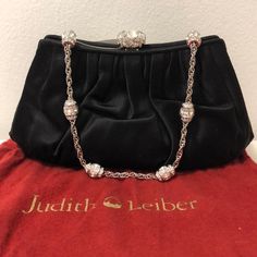 Great Discount For A Brand New Judith Leiber. Black Satin Pleated Evening Bag With Silver And Stone Details. Metallic Copper Interior With A Card Slot And Zipper Compartment. Push Lock Closure For Easy Opening. Includes Authenticity Card And Dust Bag. Timeless And Elegant! Approx 8” (5.5” At Opening) X 4” Elegant Formal Shoulder Bag With Removable Pouch, Elegant Black Clutch With Magnetic Closure, Elegant Black Evening Bag With Removable Pouch, Elegant Black Shoulder Bag For Formal Occasions, Elegant Clutch With Magnetic Closure And Shoulder Bag Shape, Elegant Black Evening Bag With Magnetic Closure, Luxury Bags With Magnetic Closure For Events, Elegant Formal Evening Bag With Removable Pouch, Designer Formal Evening Shoulder Bag