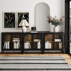 a black and white area rug in front of a bookcase with books on it