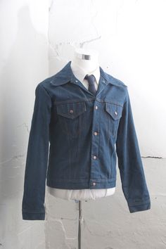 "This is a classic piece of vintage work wear. It is a tough and sturdy denim with red quilted lining. This coat was built to keep you warm. It would be perfect over a flannel. This would be as good in the garage as out in the field. Size:  TAG READS: 42 * Chest: 44\" * Sleeve Length: 25.5\"  * Shoulder: 18.5\" * Length: 24\" {measured on the back}  All measurements are taken with garments lying flat. Check out our Additional Policies & FAQ section for detailed sizing information: https://www.et Classic Collared Denim Blue Jacket, Classic Cotton Denim Jacket With Snap Buttons, Classic Collared Denim Jacket In Blue, Classic Collared Denim Jacket In Denim Blue, Vintage Single Breasted Denim Jacket For Winter, Classic Cotton Denim Jacket, Vintage Single-breasted Denim Jacket For Winter, Classic Collared Outerwear In Medium Wash, Retro Denim Blue Outerwear With Button Closure