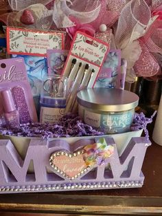 a gift basket filled with personal care items for mom on top of a wooden table