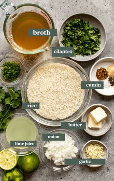 ingredients for broccoli soup laid out in bowls on a gray surface, including rice, cilantro, onion, and lime