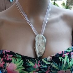 This Necklace It's Made With A Stone Seashell Very Unusual Found On The Beaches Of Myrtle South Carolina It's Been Adorned With A White Ribbon And Double Corded Silver Clasp It Can Be Worn 4 Dress Occasion Or Casual. No Two Seashells Are Ever The Same. The Seashell Seems To Have A Little Bit Of Mother Pearl Type Of Listening To It When The Sun Hits It And Yet Erosion Has Caused Another Texture On It As Well It Has An 8in Drop From Neck To Seashell Made Exclusively For My Salon Elegant Shell Necklace For Summer Beach Occasions, Elegant Shell Necklace For Summer Beach, Elegant Shell Strand Necklace For Summer, Elegant Strand Shell Necklace For Summer, Elegant Summer Shell Strand Necklace, Elegant Shell Necklace For Summer, Unique Beach Necklaces For Summer, Unique Summer Beach Necklaces, Types Of Listening