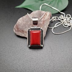 Visit our on-line shop at: Etsy.com/shop/AlbuquerqueDesigns *sterling silver necklace pendant *rectangle shape pendant with silver box chain necklace 18 inches long *southwestern jewelry *red coral *calibrated pre-cut stones in millimeter and shape of stone: 14x10nn rectangle shape *back of jewelry items are all covered / do not show the back of stones *all jewelry items are made to ship, slight variations in stones will occur comparing to pictures. *size of a penny is 19mm or a dime is 18mm in Silver Rectangular Necklace With Polished Finish, Red Rectangular Jewelry With Polished Finish, Gift Necklace With Polished Finish And Rectangular Pendant, Classic Necklace With Rectangular Stone As Gift, Rectangular Pendant Necklace With Box Chain, Elegant Red Rectangular Necklace, Classic Sterling Silver Necklace With Rectangular Pendant, Silver Sterling Silver Necklace With Rectangular Stone, Red Rectangular Sterling Silver Jewelry