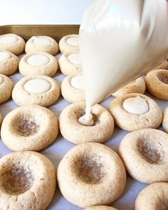 doughnuts are being made with white icing