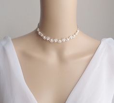 This is an original design by © Isabella Bridal. Details - Swarovski pearls - Lobster clasp closure with 2 inches extender chain. Feel free to contact me with any questions! Custom orders welcome. All orders will ship within 48 hours, except for weekends ALL ORDERS ARE SHIPPED VIA USPS FIRST CLASS WITH TRACKING. Handmade in the USA This item is Made-to-Order and therefore is a final sale. White Bridal Pearl Choker Necklace, Delicate Beaded Pearl Necklace For Wedding, White Pearl Bridal Necklace For Bridal Shower, Elegant White Bridal Necklace For Bridal Shower, Adjustable Pearl Chain Bridal Necklace For Weddings, Adjustable Pearl Embellished Bridal Necklace For Wedding, White Pearl Bridal Accessories For Anniversary, Pearl White Bridal Pearl Accessories For Wedding, Adjustable Pearl Chain Necklace For Wedding