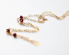 Custom Length Raw Ruby Necklace, Delicate 14k Gold Filled / Sterling Silver Choker Four teeny-tiny genuine ruby on a dainty gold filled or sterling silver necklace. A delicate and stunning piece, great for both casual wear and formal. These sparky stones are about 3 mm. Comes in: ◼︎ 14k gold filled chain ◼︎ Sterling silver chain Ruby is the birthstone of July. Ruby: Vitality, Prosperity, Courage, High Energy Ruby has been long used as a stone to increase passion and to bring and increase romanti Birthstone Necklace Mothers, Raw Ruby, Raw Stone Necklace, Sterling Silver Choker, Ruby Necklace, Silver Choker, Gold Choker, July Birthstone, High Energy