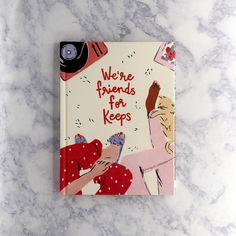 there are friends for keeps book on the marble counter top with an image of two people hugging each other