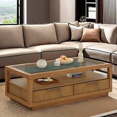 a living room with a couch, coffee table and bookshelf in the corner