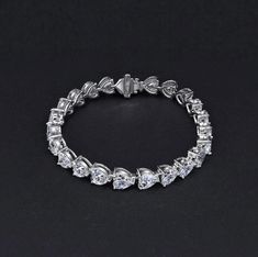 Information Metal: 925 Sterling Silver; Chain Length/Perimeter: 160mm/170mm/180mm; Plating Color: White Gold Gem type: Sona Simulated Diamond Stone Shape: Heart Cut(6*6mm) Number of Stones 24; Stone Color: White Stone Elegant Silver Diamond Heart Bracelet, Formal Heart-shaped Diamond Accented Bracelet, Formal Heart Cut Bracelet With Diamond Accents, Luxury Silver Diamond Heart Bracelet, Formal Heart Bracelet With Diamond Accents, Elegant Formal Heart Cut Tennis Bracelet, Elegant Round Cubic Zirconia Heart Bracelet, Elegant Cubic Zirconia Heart Bracelet, Elegant Round Heart Bracelet With Cubic Zirconia