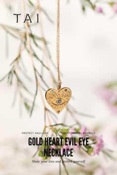 A gold necklace featuring a heart-shaped pendant with an evil eye design, embellished with colorful accents, hanging delicately against a soft, floral backdrop. Gold Spiritual Heart Necklace, Spiritual Gold Heart Necklace, Gold Heart-shaped Spiritual Necklace, Gold Heart Evil Eye Jewelry, Heart-shaped Gold Evil Eye Jewelry, Gold Heart-shaped Evil Eye Jewelry, Symbolic Gold Heart-shaped Necklaces, Heart Evil Eye, Set Yourself Free