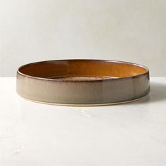 a brown bowl sitting on top of a white counter