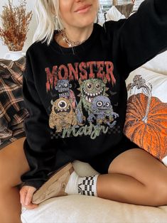 Show off your spooky aesthetic in our trendy monster mash shirt. This retro halloween sweatshirt is slightly distressed and oversized, perfect for a cozy fall outfit. * Ultra soft * Distressed design * Pre-shrunk * Universal fit * True to size * DTG Printing * Brand - Gildan Refunds/Exchanges: * No Cancellations * No returns/exchanges * All sales are final Sizing: Our graphic tees and sweatshirts are a true to size standard unisex fit. For an oversized look, please size up. For a TShirt dress fi Oversized Grunge Halloween Sweater, Halloween Punk Style Streetwear Sweater, Oversized Punk Halloween Sweatshirt, Oversized Punk Sweatshirt For Halloween, Punk Halloween Sweater For Streetwear, Halloween Grunge Long Sleeve Sweater, Oversized Black Sweatshirt With Cartoon Print, Spooky Black Sweatshirt With Graphic Print, Grunge Halloween Sweater For Streetwear