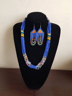 "Necklace comes with matching earrings. Dimensions: 27\" Main color: blue Available in different colors.  More necklaces here; https://www.etsy.com/shop/PrimeBeadsKe?ref=seller-platform-mcnav&section_id=33399833 All items are shipped through dhl express!" Blue Beaded Jewelry Sets For Gift, Blue Jewelry Sets With Round Beads As A Gift, Blue Beaded Round Beads Jewelry Sets, Blue Large Beaded Dangle Necklaces, Blue Beaded Dangle Necklace With Large Beads, Blue Beaded Jewelry Sets, Blue Large Beads Dangle Necklace, Blue Beaded Jewelry Sets With Round Beads, Blue Dangle Beaded Necklace With Large Beads