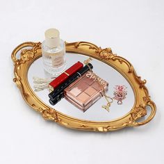 there is a mirror with some cosmetics on it and a bottle in the middle of it