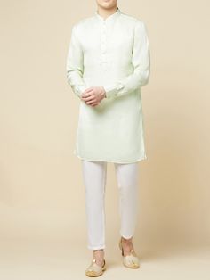 This Mint Green Kurta Bundi Jacket Set will instantly give an elegant look. This 3 piece kurta bundi set features a mint green mirror embroidered bundi jacket with a mint green kurta, front button placket, and a mandarin collar. It is paired with white churidar pants. An ideal outfit for traditional occasions, and special events.

Size Chart For Men





	
	
					Men's Size Chart
		

		
		
						
				Size Chart For Men
				Custom Size Measurement Guide
			
			
				
				
				Custom Size Measureme Unstitched Pista Green Kurta For Spring, Fitted Dabka Kurta For Spring, Spring Fitted Kurta With Dabka Detailing, Spring Designer Traditional Wear In Pista Green, Green Long Sleeve Sherwani For Spring, Spring Fitted Dabka Kurta, Traditional Pista Green Kurta For Spring, Designer Sherwani For Spring, Fitted Bandhgala Straight Kurta For Spring