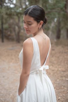 Gorgeous 100% Cotton Dress with Corton Lining.  The dress is off-white, has pockets, is backless with 2 ties & zipper at the waist.  Fun to wear to weddings, parties, an evening out in the summer, baby shower, any formal or casual event.  Has a wonderful swing skirt to make anyone want to twirl.  You cannot go wrong with this beautifully made dress.  Please make sure you use the size chart for the correct size, the dress does run small, so don't choose by your normal dress size number - choose based upon your measurements. Model is wearing a Size 6 and her measurements are as follows:  Please note, the model is smaller than the size 6. Height:  5'4" Chest:    34" Waist:     27" Hips:      37" White Backless Dress With Back Zipper For Summer, White Backless Summer Dress With Zipper, Backless Dress With Bow Tie Back For Garden Party, Backless Bow Tie Back Dress For Garden Party, White Tie Back Backless Dress, Summer Wedding Dress With Bow Tie Back, White Sleeveless Backless Dress With Tie Back, White Sleeveless Tie Back Backless Dress, Summer Low Back Dress With Back Zipper