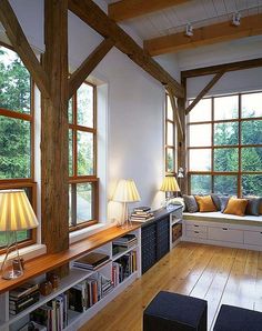 a living room filled with lots of furniture next to large windows covered in wood planks