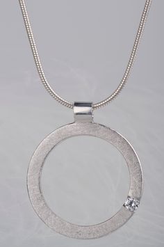 Are you looking for a gift idea for women? How about this minimalist and delicate sterling silver pendant necklace? You can choose which stone you prefer - diamond or zircon. Combination of the brilliant and delicate stone and rough, scratched silver surface makes the necklace look modern, but still subtle and elegant. Since both stones are birthstones (diamond is April birthstone and zircon is December birthstone) this necklace will be a great birthday gift for women. But it would also be a goo Minimalist Silver Jewelry With Single Cut Diamonds, Silver Jewelry With Single Diamond And White Topaz, Modern Sterling Silver Jewelry With Single Diamond, Modern Sterling Silver Necklace With Diamond Cut, White Gold Tension Set White Topaz Jewelry, Silver Jewelry With Tension Setting White Topaz, Silver Necklace With Single Cut Diamonds For Everyday, Everyday Silver Necklace With Single Cut Diamonds, Minimalist Sterling Silver Jewelry With Brilliant Cut