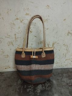 "Baobab bags are handwoven and the material used is from the bark of the Baobab tree that grows wild in Africa. These beautiful baobab baskets are made from Baobab tree bark, the fibers are harvested from the tree (this does not affect the tree, and the fibers grow back) then soaked for the fiber to be soft for weaving, it's then handwoven to make this gorgeous unique patterned bags. This baobab basket can be used as a storage basket,market basket, shopping basket, weekend basket bag, beach bag. Handmade Brown Bucket Bag, Brown Basket Crochet Bag With Leather Handles, Brown Crochet Basket Bag With Leather Handles, Handwoven Natural Bucket Bag As Gift, Traditional Bags In Natural Fiber For Everyday Use, Eco-friendly Jute Bags With Weaving, Handmade Eco-friendly Brown Straw Bag, Handwoven Brown Bags In Natural Fiber, Artisan Basket Bag As Gift