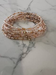 Blush Wrap bracelet is made with premium elastic and a mix of Japanese seed beads, crystals, glass and 14k rose gold-filled beads in shades of rose and soft gold Blush can be worn as a necklace or as a layered bracelet for an effortless, layered look. Available in 3 sizes. The small size at 44 inches will create the look of 7 stacked dainty bracelets on a 6-6.5 inch wrist. Kindly select the size that will best suit you. Thank you for choosing a Philia Bijoux accessory. Rose Gold Beaded Jewelry For Party, Rose Gold Beaded Necklace For Party, Rose Gold Beaded Bracelet With Round Beads, Elegant Rose Gold Beaded Bracelets With Tiny Beads, Elegant Rose Gold Jewelry With Colorful Beads, Pink Beaded Bracelets With Gold Beads For Party, Elegant Rondelle Beaded Bracelets With Colorful Beads, Beaded Pink Gold Bracelets, Elegant Rondelle Beaded Bracelets