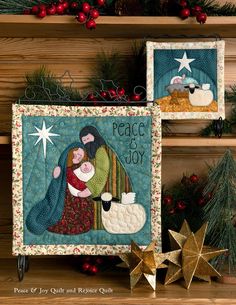 two quilted wall hangings decorated with christmas decorations and stars on top of wooden shelves