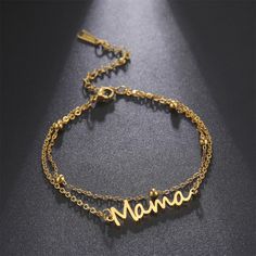 Keep your beloved mom close to your heart with this stylish bracelet. Crafted from stainless steel, the bracelet features a mama nameplate, and is available in either gold or silver colors, or in string colored red or black. Perfect for any mom, it is a wonderful way to show her that she is loved. Minimalist Metal Bracelets For Mother's Day, Elegant Metal Name Bracelet For Mother's Day, Gold Charm Bracelet For Mother's Day, Trendy Personalized Stainless Steel Bracelets, Personalized Metal Bracelets For Mother's Day, Minimalist Stainless Steel Bracelets For Mother's Day, Mother's Day Gift Stainless Steel Name Bracelet, Mother's Day Stainless Steel Name Bracelet, Trendy Metal Bracelets For Mother's Day