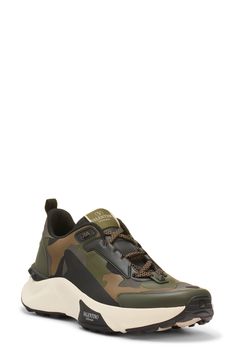 Tessellated camo and a hiker-inspired silhouette add rugged touches to a streetwear-essential sneaker detailed with signature logo accents at the tongue and sidewall. Lace-up style Removable insole Leather and textile upper/textile lining/synthetic sole Made in Italy Designer Shoes Low-top Outdoor Sneakers With Logo Print, Sporty Sneakers With Logo Print For Outdoor, Sporty Outdoor Sneakers With Logo Print, Camouflage Lace-up Sneakers For Streetwear, Rugged Sneakers For Streetwear, Low-top Camouflage Sneakers With Rubber Sole, Sporty Camouflage Sneakers For Sports, Black Sneakers With Lug Sole For Outdoor, Low-top Camouflage Sneakers For Outdoor