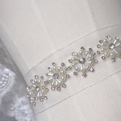 ❤100% handmade, satin rolled roses, suit for bouquet, flower girl basket, wedding deocors ❤ This listing is for 1 meter Measurements: pearl flower: Width- 1.2 inches (widest part of the flower) This sash is made with high quality rhinestones and pearls. A heirloom piece that will add a touch of glamour to any dress. Elegant Bridal Belt With Handmade Flowers For Weddings, Elegant Handmade Flower Sashes For Party, Elegant Sashes With Handmade Flowers For Party, Elegant Bridal Belt With Handmade Flowers, Elegant Bridal Belt With Flower Decoration For Wedding, Elegant Bridal Belt With Flower Decoration, Bridesmaid Sash, Embroidery Fashion Detail, Hand Beaded Embroidery